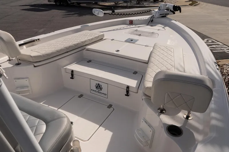 Slide: The Image of 2020 Blue Wave 2600 PureBay boat interior with cushioned seating and storage compartments. - 16