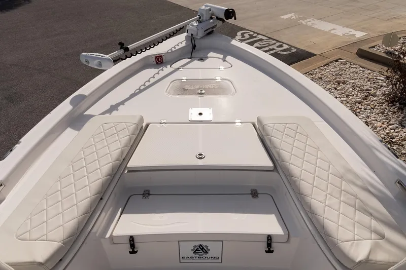Slide: The Image of 2020 Blue Wave 2600 PureBay boat with cushioned seating and trolling motor on deck. - 17