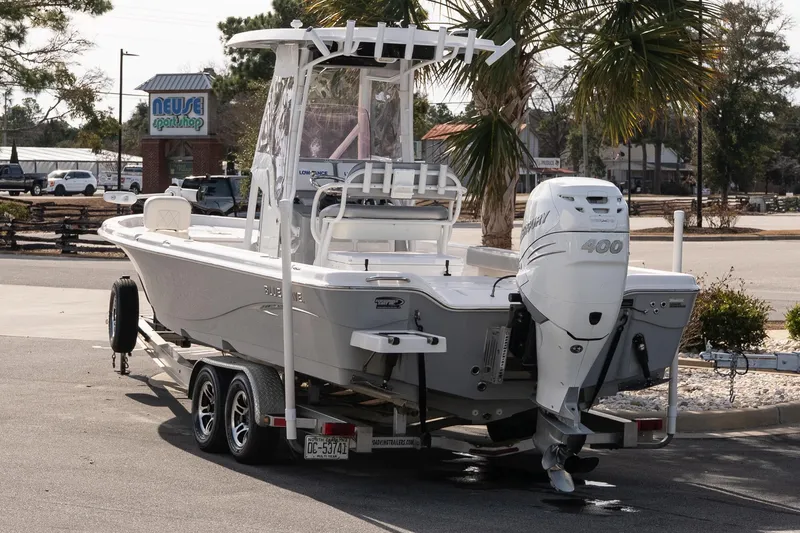 Slide: The Image of 2020 Blue Wave 2600 PureBay boat on trailer with powerful outboard motor. - 4