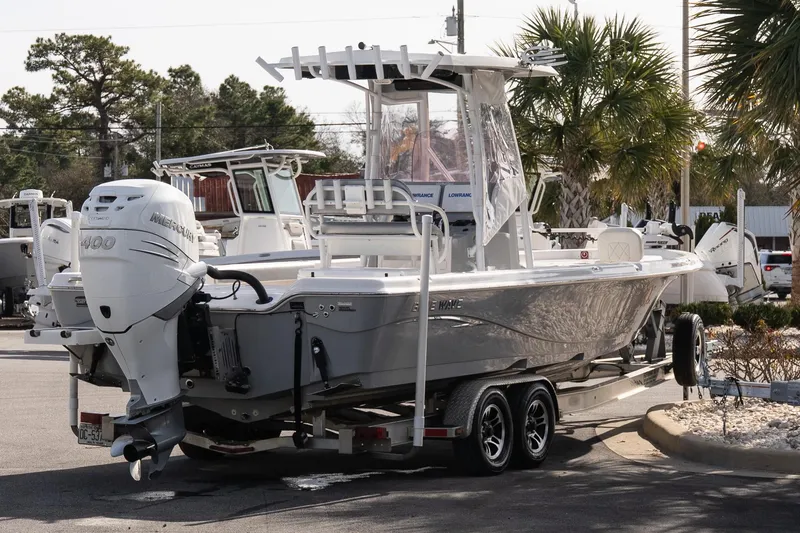 Slide: The Image of 2020 Blue Wave 2600 PureBay boat on trailer with Mercury 400 engine, parked outdoors. - 7