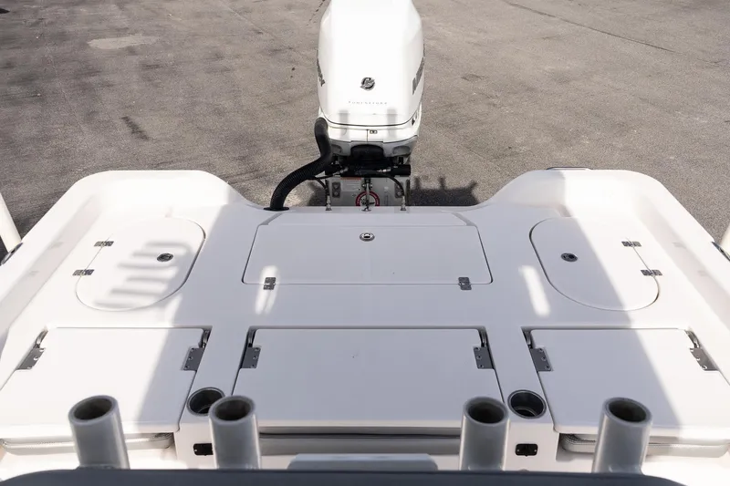 Slide: The Image of 2020 Blue Wave 2600 PureBay boat deck with motor, featuring storage compartments. - 9