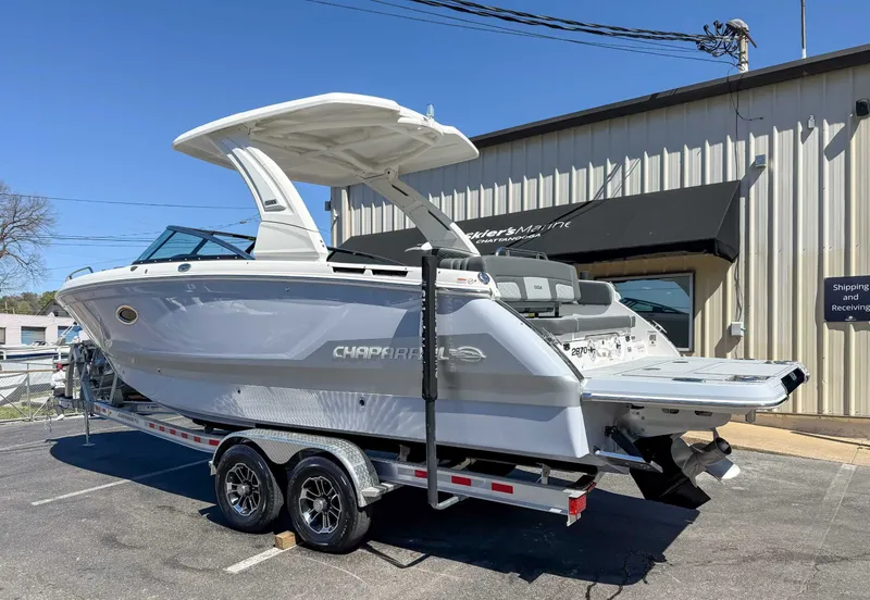 Slide: The Image of 2025 Chaparral 2870 SSX boat on trailer outside a building. - 8