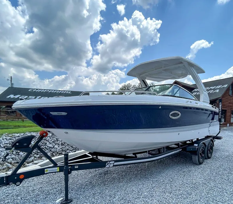 Slide: The Image of 2025 Chaparral 267 SSX boat on trailer under cloudy sky. - 3