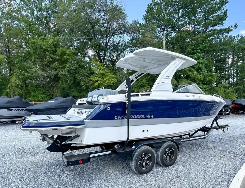 Slide: The Image of 2025 Chaparral 267 SSX boat parked on trailer outdoors. - 6