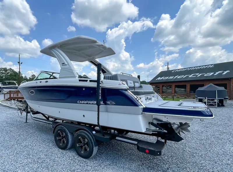 Slide: The Image of 2025 Chaparral 267 SSX boat on trailer, blue and white design. - 7