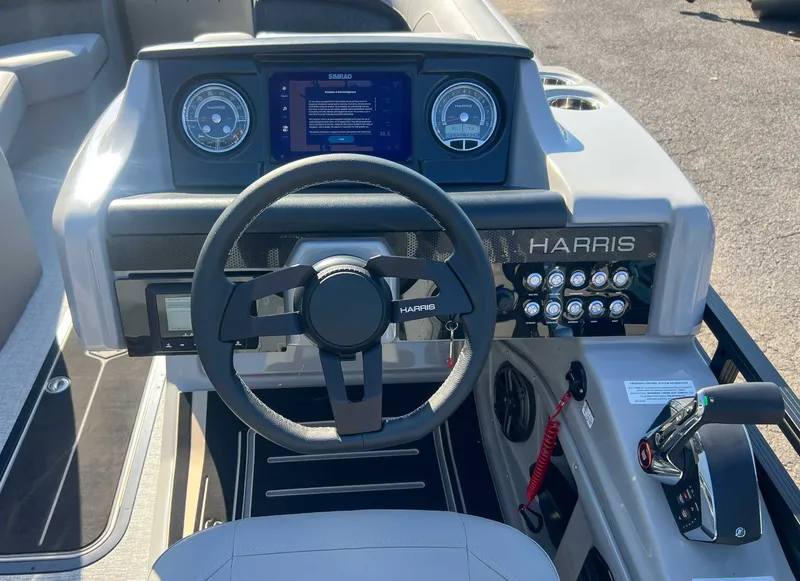 Slide: The Image of Harris Solstice 230 SLDH 2025 boat dashboard with steering wheel and controls. - 19