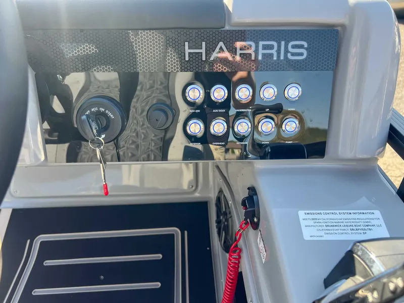 Slide: The Image of Dashboard of 2025 Harris Solstice 230 SLDH with switches and ignition key. - 21
