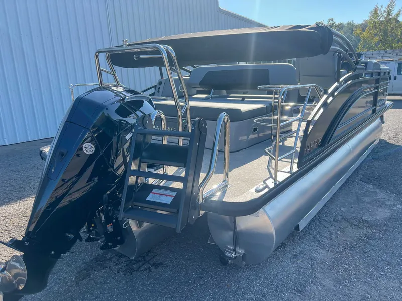 Slide: The Image of 2025 Harris Solstice 230 SLDH pontoon boat parked outdoors. - 7