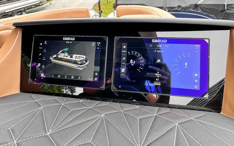 Slide: The Image of 2025 Harris Grand Mariner 230 SLDH dashboard with Simrad displays. - 21