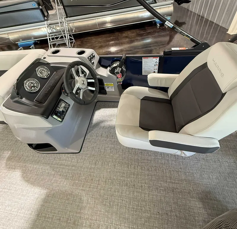 Slide: The Image of Interior of 2025 Harris Cruiser 230 CWDH with helm and seating. - 15