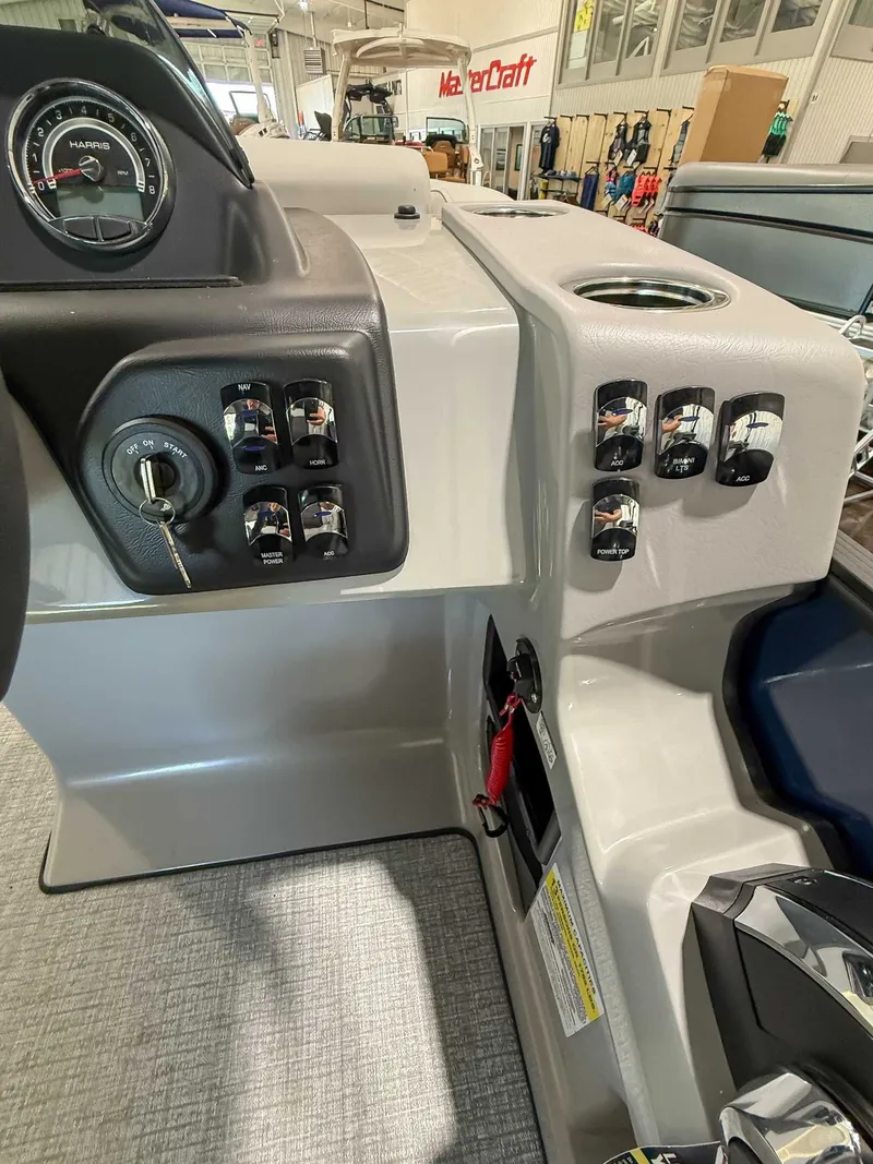 Slide: The Image of Dashboard of 2025 Harris Cruiser 230 CWDH with switches and ignition key. - 17