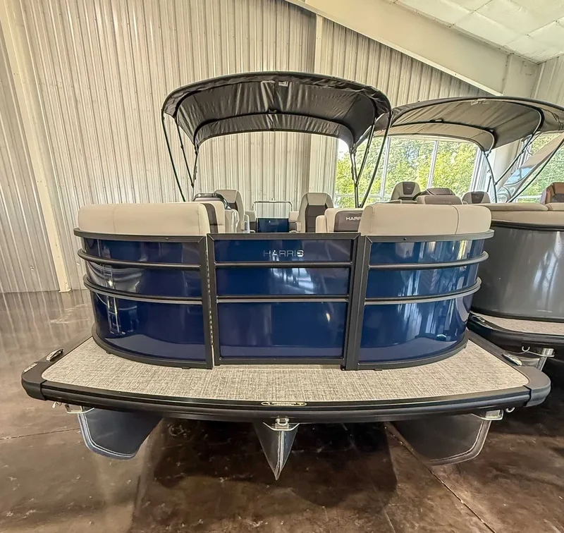 Slide: The Image of Harris Cruiser 230 CWDH 2025, blue pontoon boat indoors. - 4