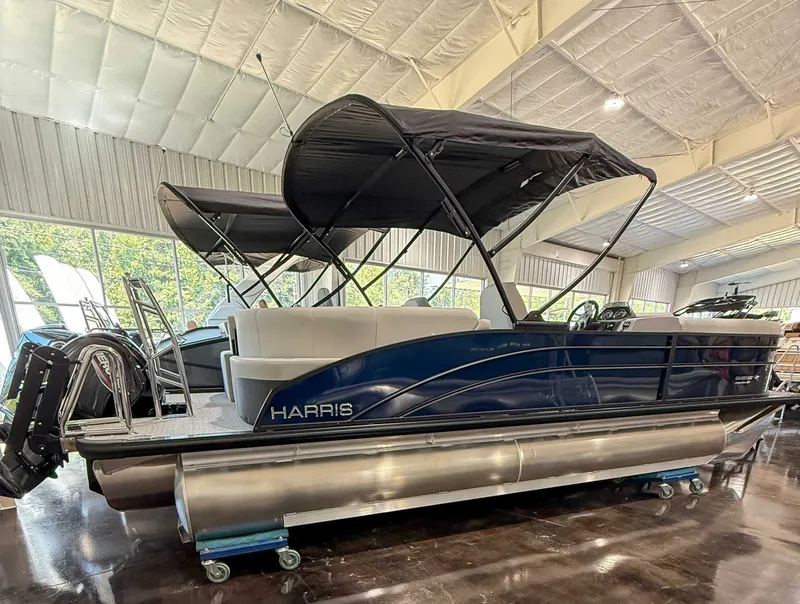 Slide: The Image of 2025 Harris Cruiser 230 CWDH pontoon boat in a showroom. - 6
