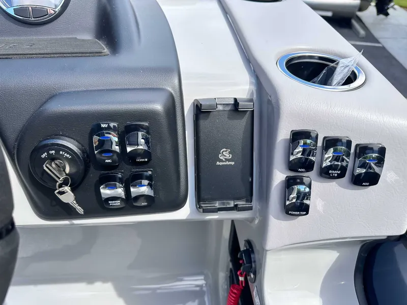 Slide: The Image of Dashboard of 2026 Harris Cruiser 210 SLDH with switches and ignition key. - 18