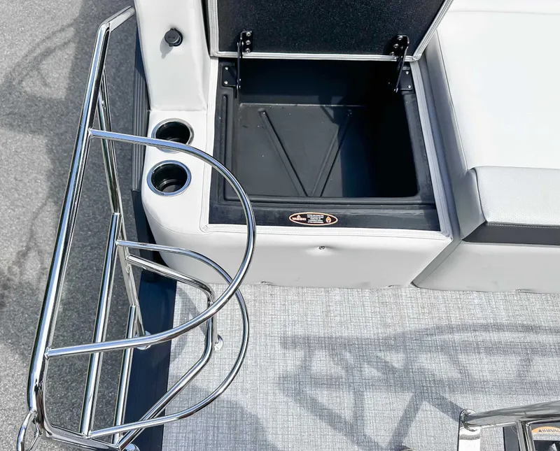 Slide: The Image of Harris Cruiser 210 SLDH 2026, open storage compartment and cup holders. - 23