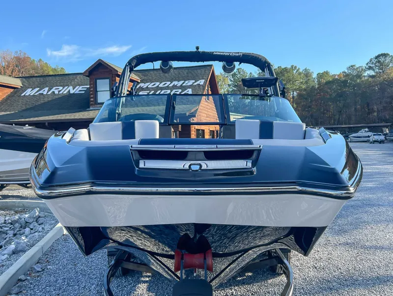 Slide: The Image of 2024 MasterCraft X22 boat on gravel lot in front of building. - 4