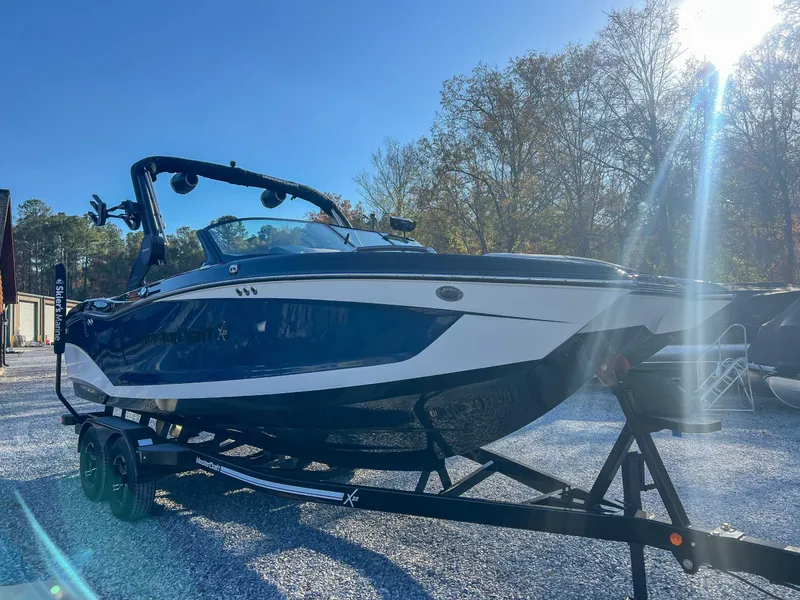 Slide: The Image of 2024 MasterCraft X22 boat on trailer in sunlight. - 5