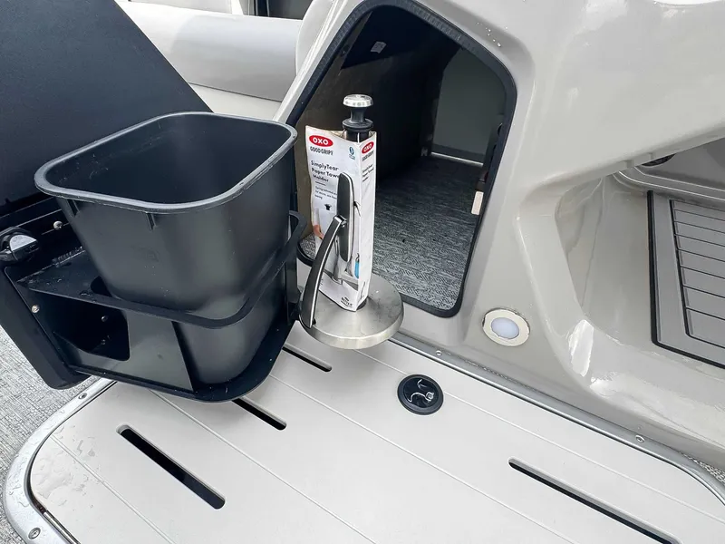 Slide: The Image of Interior of 2024 Premier 230 SunSation RF with storage and trash bin. - 13