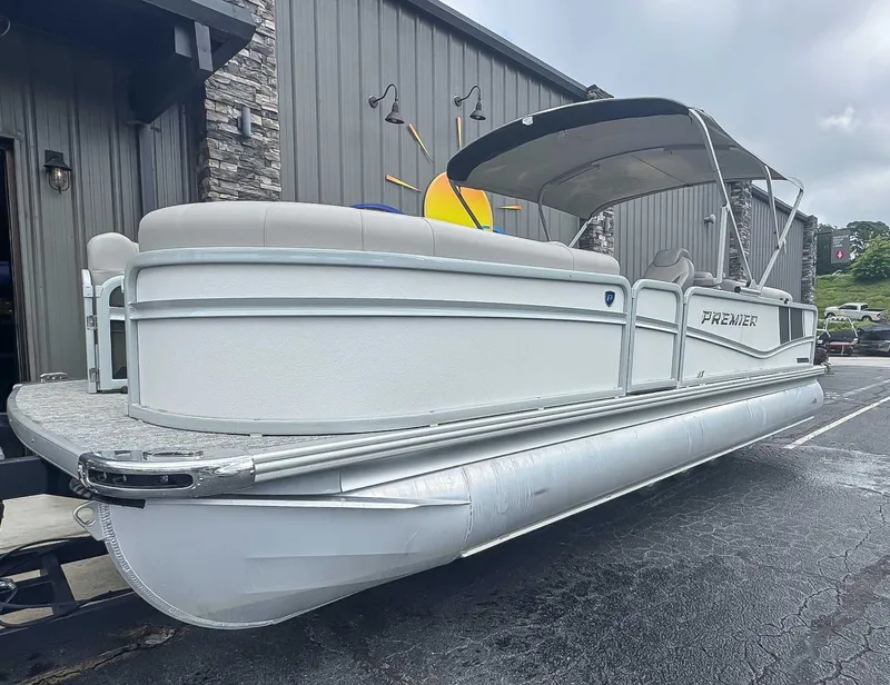 Slide: The Image of 2024 Premier 230 SunSation RF pontoon boat in front of a building. - 3