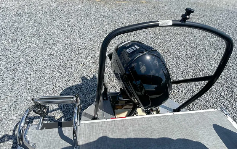 Slide: The Image of Premier 220 SUNSCAPE RL 2025 with outboard motor on gravel surface. - 21