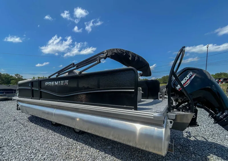 Slide: The Image of 2025 Premier 220 SUNSCAPE RL pontoon boat on gravel, blue sky. - 7