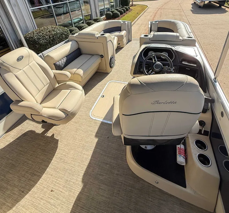 Slide: The Image of Interior of a 2018 Barletta L23UC pontoon boat with beige leather seats. - 10