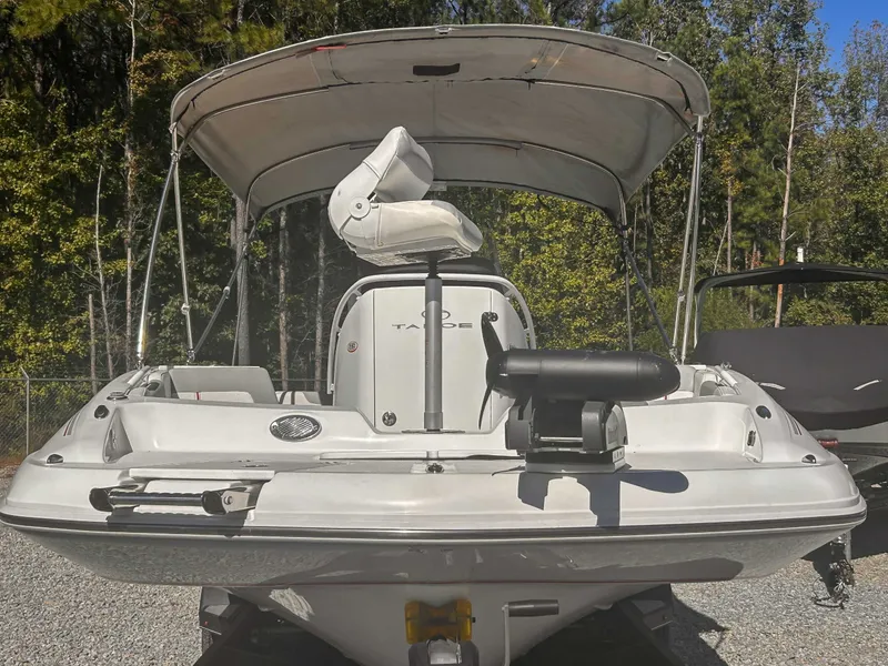 Slide: The Image of 2020 Tahoe 2150 boat with canopy parked outdoors. - 4