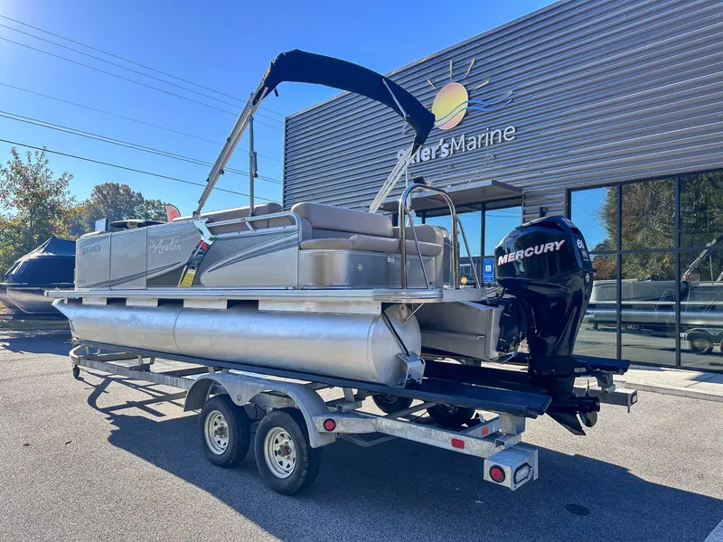 Slide: The Image of 2015 Avalon 2223 LS pontoon boat outside a marine store. - 10