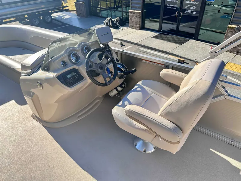 Slide: The Image of Interior of a 2015 Avalon 2223 LS boat with steering console. - 18