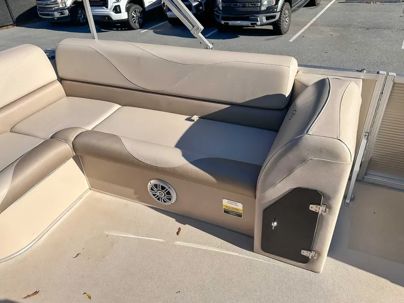 Slide: The Image of Interior of a 2015 Avalon 2223 LS boat with beige upholstered seating. - 23