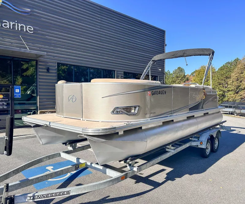 Slide: The Image of 2015 Avalon 2223 LS pontoon boat on trailer outside a building. - 3