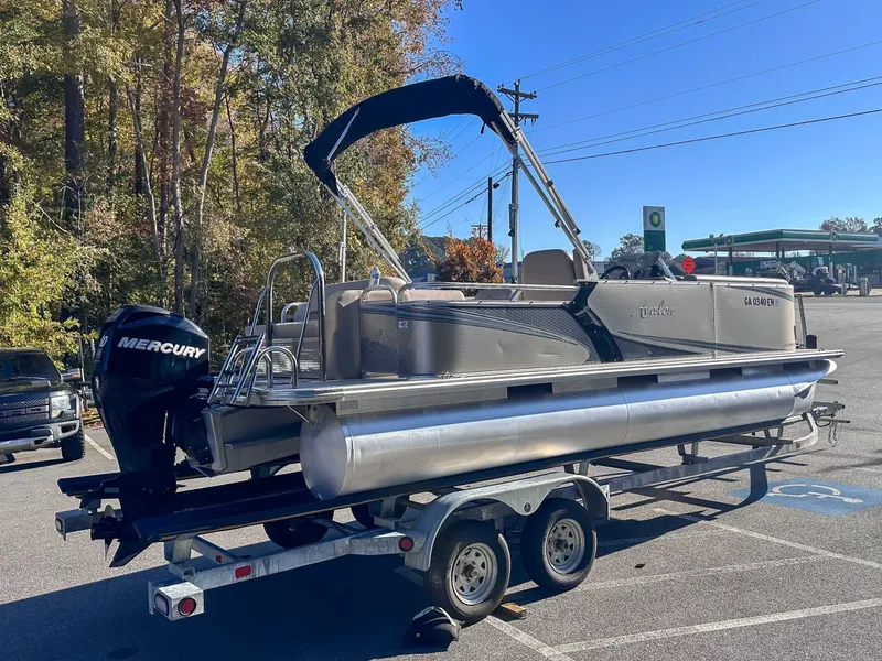 Slide: The Image of 2015 Avalon 2223 LS pontoon boat parked on trailer outdoors. - 9
