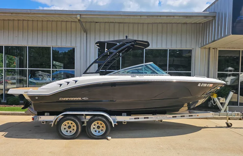 The Image of 2023 Chaparral 21 SSi boat on trailer outside building. - 1