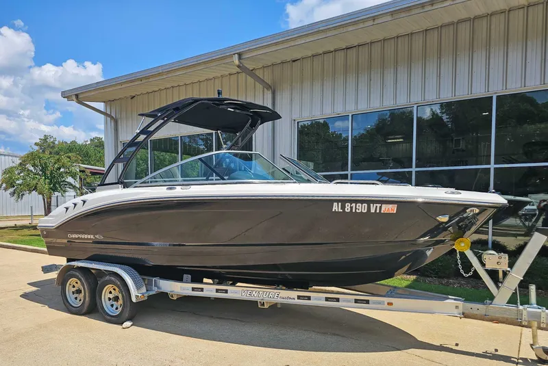 Slide: The Image of 2023 Chaparral 21 SSi boat on trailer in front of building. - 3