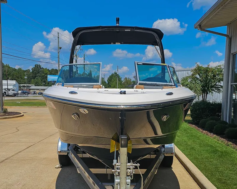 Slide: The Image of 2023 Chaparral 21 SSi boat on trailer, blue sky. - 4