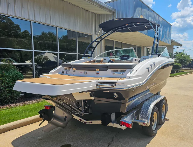 Slide: The Image of 2023 Chaparral 21 SSi boat on trailer outside building. - 8