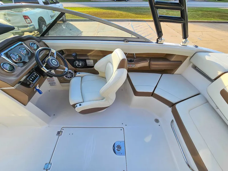 Slide: The Image of Interior of a 2017 Chaparral 216 SSi boat with steering wheel and seating. - 13