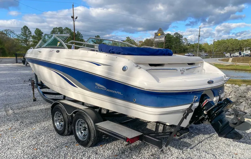 Slide: The Image of Chaparral 216 SSi 2000 on trailer, blue and white design, parked outdoors. - 7