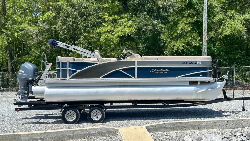 The Image of 2014 Sweetwater 200 Premium Edition pontoon boat on trailer. - 1