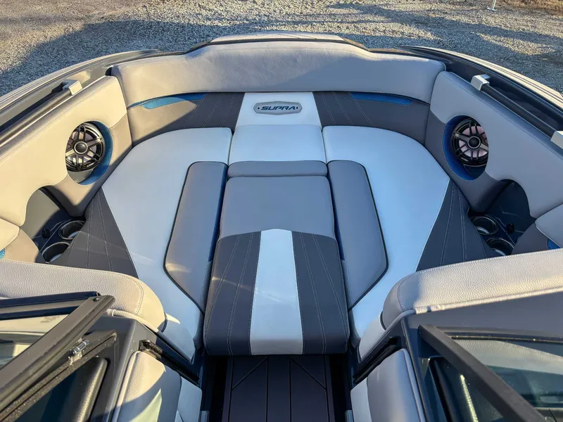 Slide: The Image of Interior of a 2020 Supra SA450 boat with gray and white seating. - 13