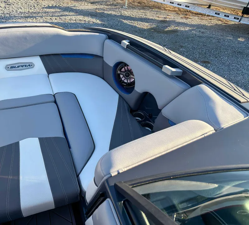 Slide: The Image of Interior of a 2020 Supra SA450 boat with gray and white seating. - 14
