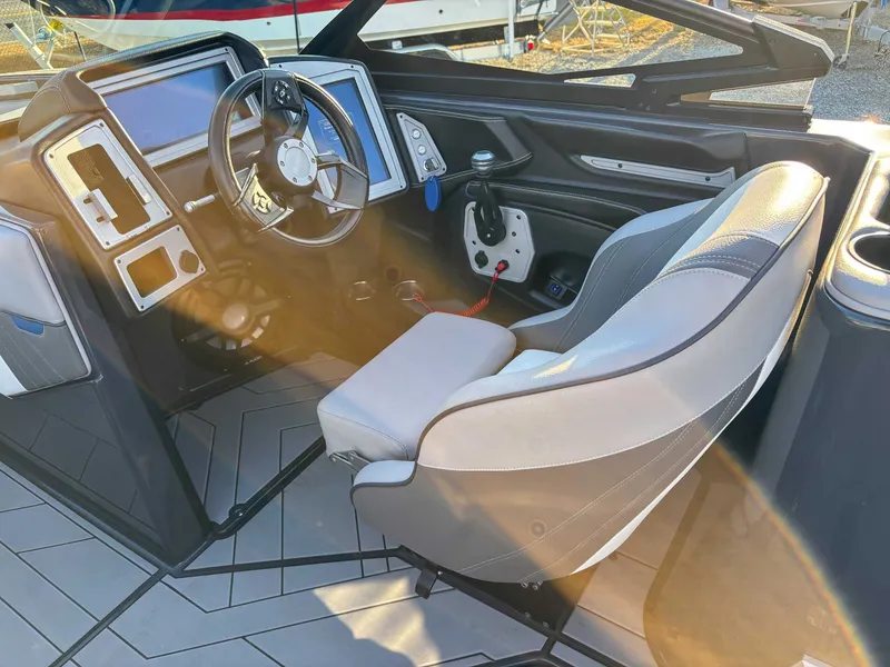 Slide: The Image of Interior of a 2020 Supra SA450 boat with steering console. - 17