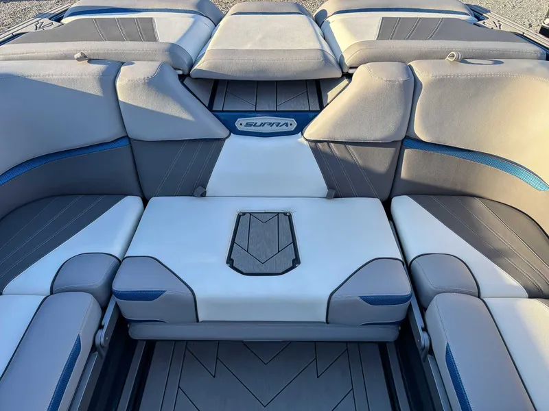 Slide: The Image of Interior of a 2020 Supra SA450 boat with gray and blue seating. - 22