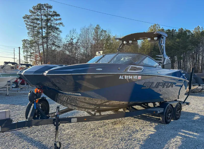 Slide: The Image of 2020 Supra SA450 boat on trailer outdoors. - 5