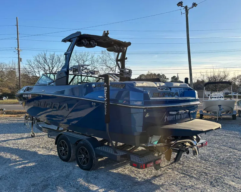 Slide: The Image of 2020 Supra SA450 boat on trailer outdoors. - 7