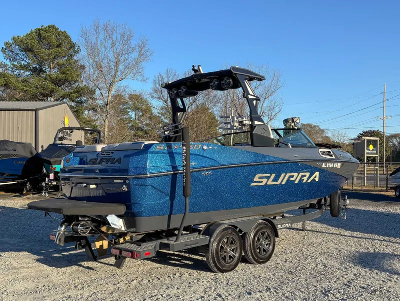 Slide: The Image of 2020 Supra SA450 boat on trailer outdoors. - 8