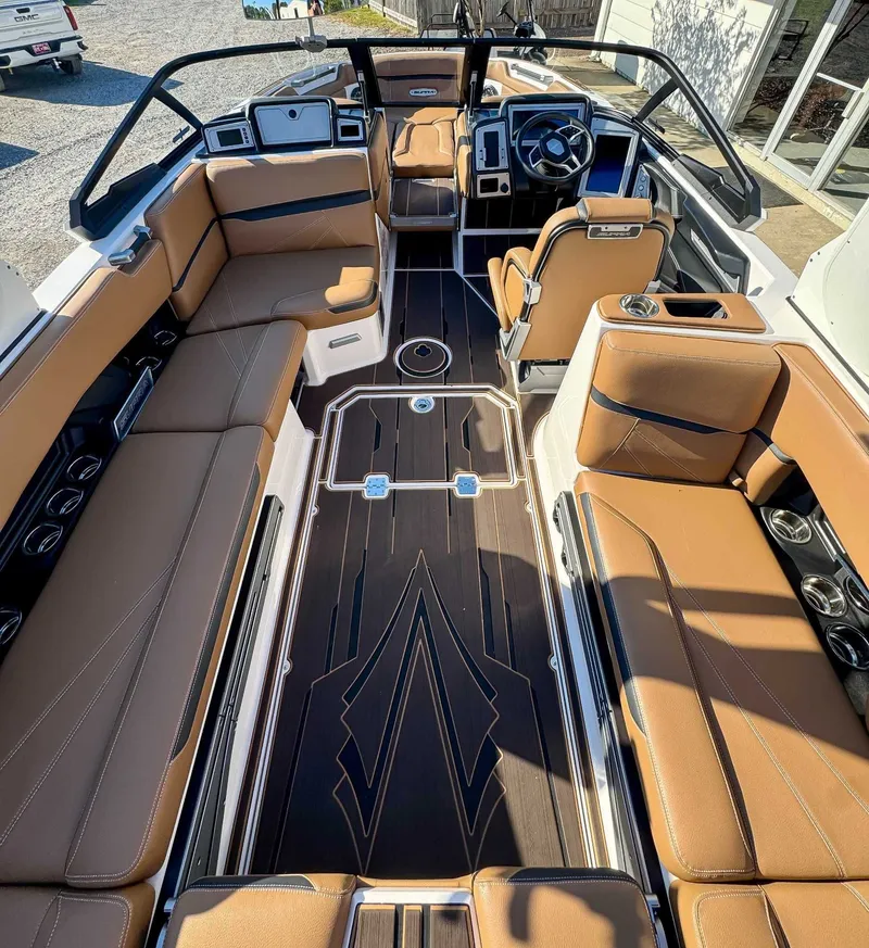 Slide: The Image of Interior of 2023 Supra SL boat with brown leather seating. - 11
