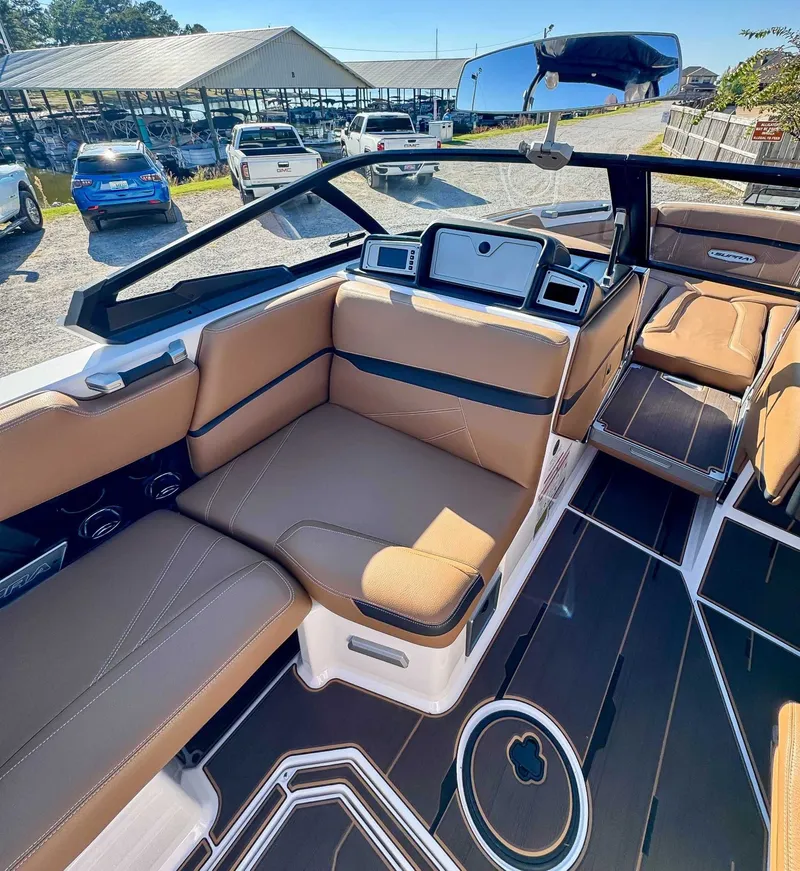 Slide: The Image of Interior of a 2023 Supra SL boat with brown seating. - 16
