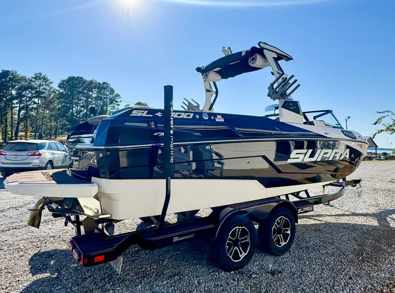 Slide: The Image of 2023 Supra SL boat on trailer in sunny weather. - 7