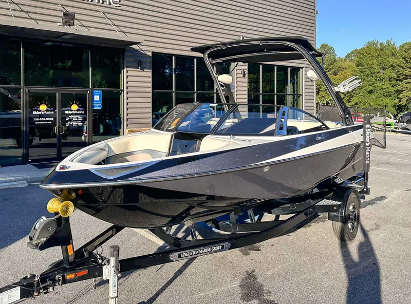 Slide: The Image of 2013 Malibu Wakesetter 20 VTX boat in front of a building. - 3